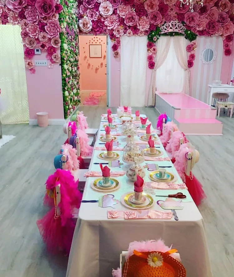 Pretty in Pink Princess Spa party room in Fort Lauderdale, decorated with a floral ceiling and a princess tea party table set for a birthday celebration